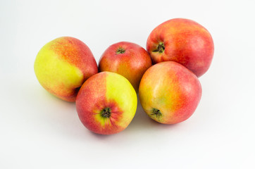 Apples on a white background, juicy red fruits. Useful fruit for a healthy diet.