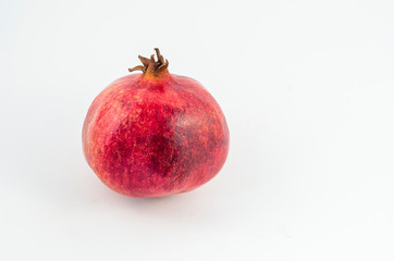 Red pomegranate on white background, juicy red fruit. Useful fruit for a healthy diet.