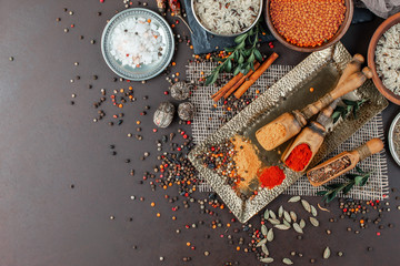 Spices and seasonings for cooking in the composition on the table - obrazy, fototapety, plakaty