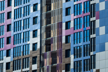 Facing the building with a ventilated facade. Aluminum colored facades. Modern facades of high-rise buildings. Construction of a large residential complex.