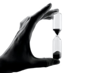 hand holding hourglass isolated on white background, black and white, sandglass