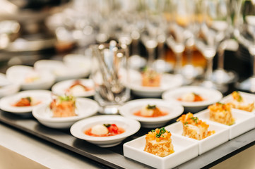 Plates with appetizers on some festive event, party or wedding reception