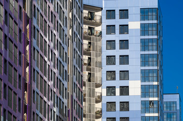 Facing the building with a ventilated facade. Aluminum colored facades. Modern facades of high-rise buildings. Construction of a large residential complex.