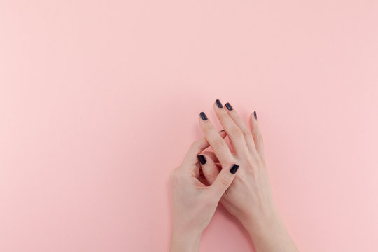 Woman's Hands With Black Manicure