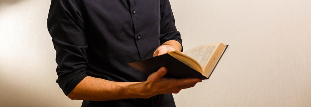 Missionary Man Holds His Bible With Interlocked Fingers To Pray.