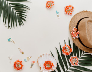 Fototapeta na wymiar Flat lay minimal summer background with flowers and hat on pastel surface