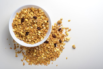 Muesli in a plate on a white background with space for text