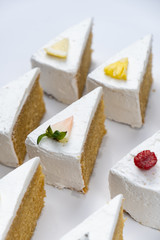 Delicious creamy minimal white cake with fruit on white background.