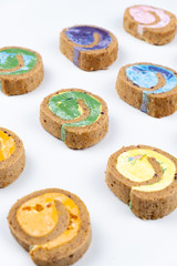 Delicious creamy colourful minimal cake roll on white background.