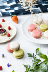 Macaron or French macaroon cookies dessert. Set on cafe table.
