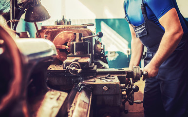 Operator working on the lathe machine, close up photo. Concept of industry