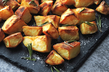 Baked potato served on a stone board. Potatoes in a rustic style