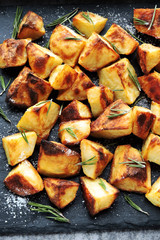 Baked potato served on a stone board. Potatoes in a rustic style