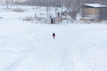 winter, leisure, sport, friendship and people concept - group of happy people sliding on the snow...