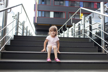 Young girl sitting on the steps