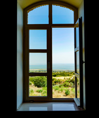 View of blue sky and sea from window