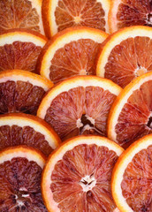Background of ripe juicy slices of blood orange. Vertical
