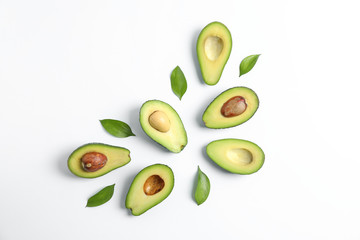 Flat lay composition with ripe avocados on white background, space for text. Top view