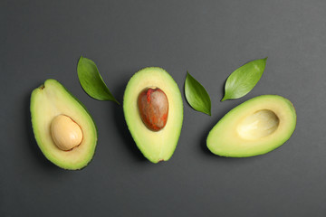 Flat lay composition with ripe avocados on black background, space for text. Top view