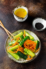 Cucumber salad with carrots and sesame seeds. Asian cuisine