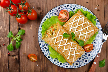 Crepes stuffed with stewed cabbage with carrots and eggs.