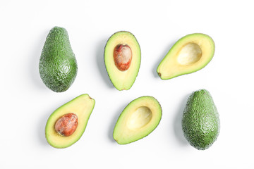 Flat lay composition with ripe avocados on white background, space for text. Top view