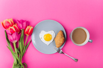 Mother's day composition.Breakfast with tulips on pink background.