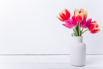 Mother's day composition.Vase with tulips and gifts