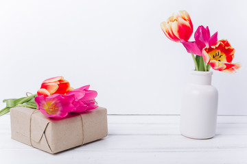Mother's day composition.Vase with tulips and gifts