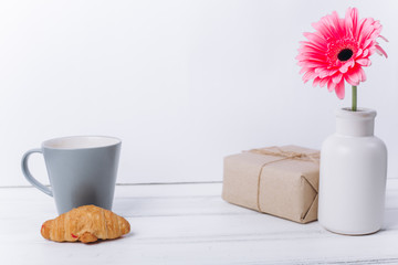 Mother's day concept.Vase with flower and gift.