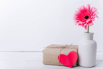 Mother's day concept.Vase with flower and gift.
