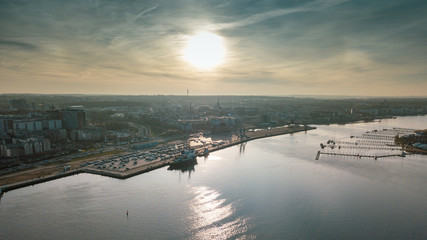 sunset over river - aerial view of the city of rostock