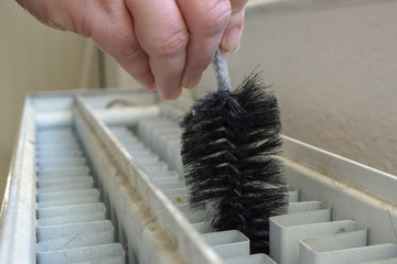 Cleaning a radiator with a brush