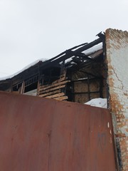 Charred and blackened remains of an building destroyed by a fire 