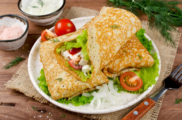 Crepes stuffed with Caesar salad, chicken, tomatoes, cheese and lettuce.