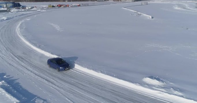 Blue subaru wrx racing on the ice ring, aerial view
