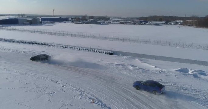 Blue and black subaru wrx racing on the ice ring, aerial view