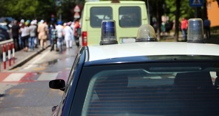 car of police in the city during parade of protesters