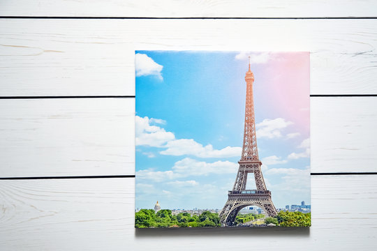Canvas print. Photo with gallery wrap method of canvas stretching on stretcher bar. Photography with image of  The Eiffel Tower (Paris, France) hanging on a white wooden wall