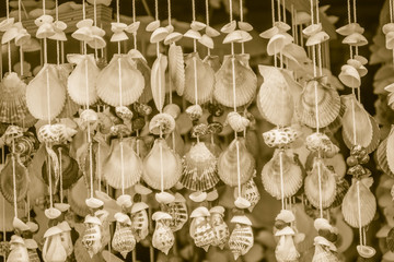 Vintage mobile made from variety seashells for background, Beautiful seashell mobile hanging in the shop for sale. Handicrafts produced by the shell wall, souvenirs from the seaside.