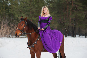 Beautiful girl in historical clothes riding a horse