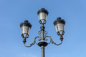 Fototapeta na wymiar street lamp in the old style against the blue sky