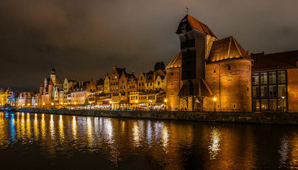 Fototapeta na wymiar The dark view of Gdansk, old town and famous crane at amaizing night with light reflections. Poland