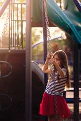 girl on a swing at playground