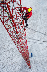 Worker climbing up on red industrial construction use safety harness, irata worker, rope access