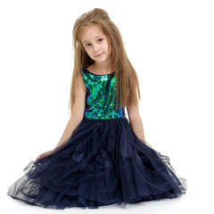 Fototapeta premium Little girl is sitting on the floor.
