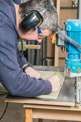 Male carpenter working in his carpentry workshop.