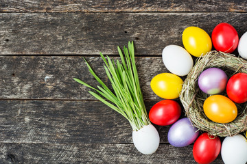 bright Easter colored eggs in Birds Nest.   Top view with copy space 