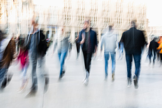 picture of people walking on a street in the city, with camera made motion blur effect