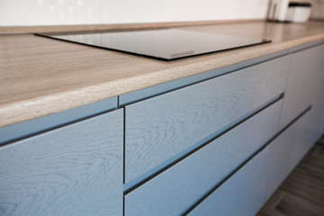 Blue and white cabinets in modern kitchen interior